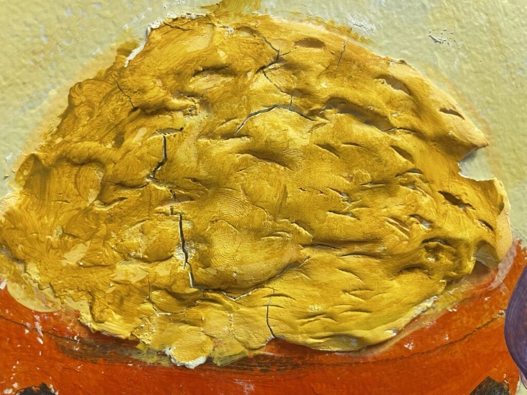 A golden honeycomb-like structure on a textured surface.