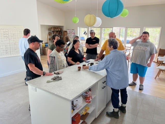 Participants gathered around kitchen island