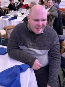 Smiling guest at banquet table with napkin