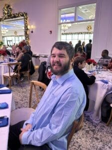 Smiling man seated at decorated banquet table