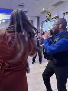 Guests dancing on a crowded holiday dance floor