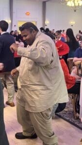 Man dancing in beige shirt and pants