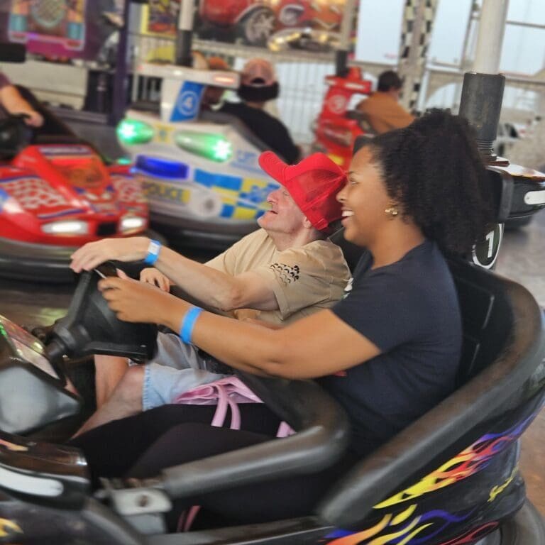 Two people enjoying a ride on a go-kart.