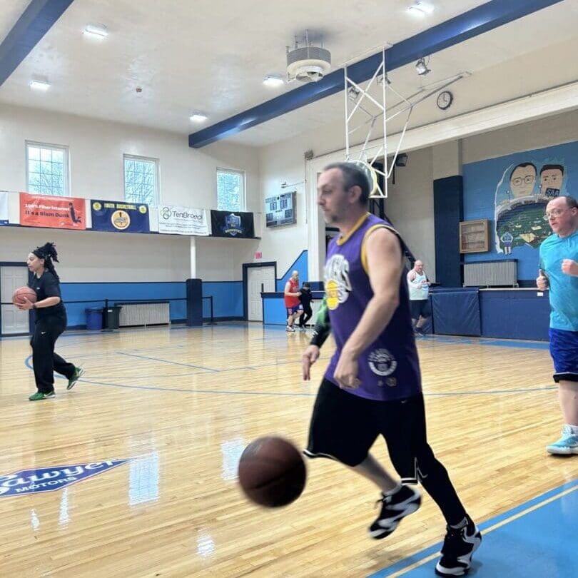 Player dribbling basketball on indoor court