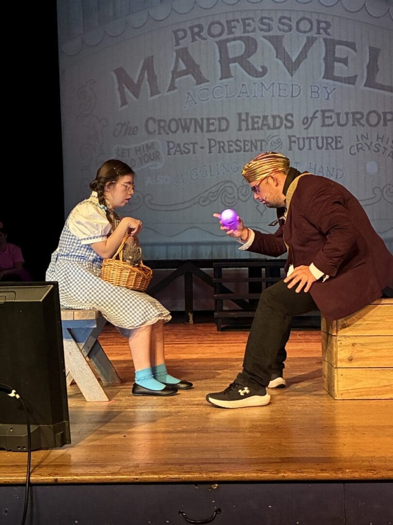Theater scene: girl and man with glowing orb