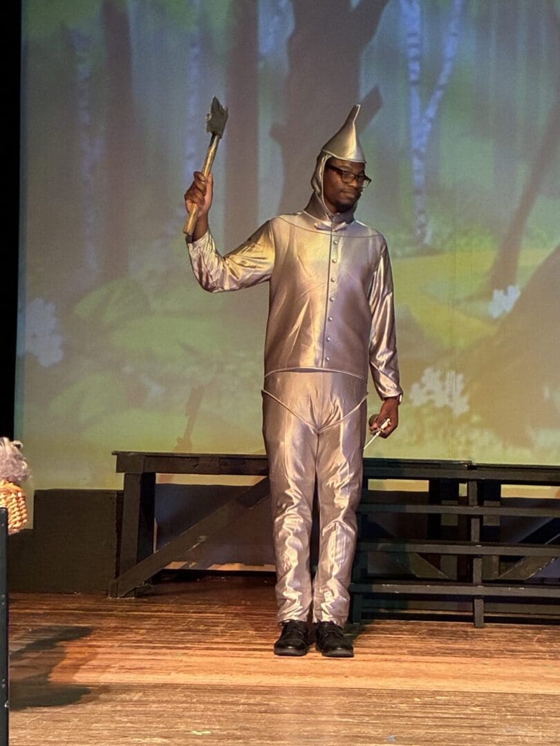 Actor in Tin Man costume holding axe
