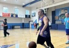 Player dribbling basketball on indoor court